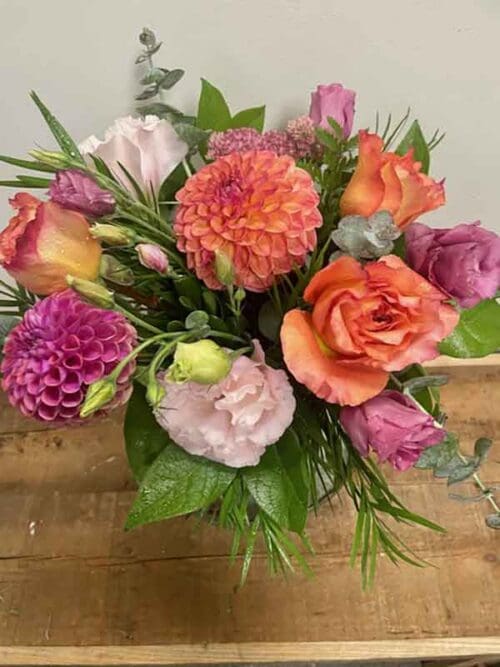 Flower arrangement with a radiant blend of coral, peach, and soft pink blooms